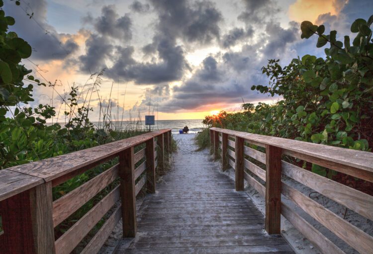 Boardwalk leading toward Delnor-Wiggins State Park at sunset s