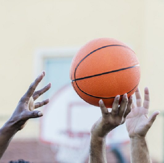 Men's basketball, hands reaching for ball