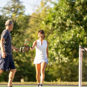 Couple plays a game of pickleball