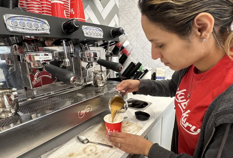 Vicky Bakery barista making freshly made Cuban coffee with cream.