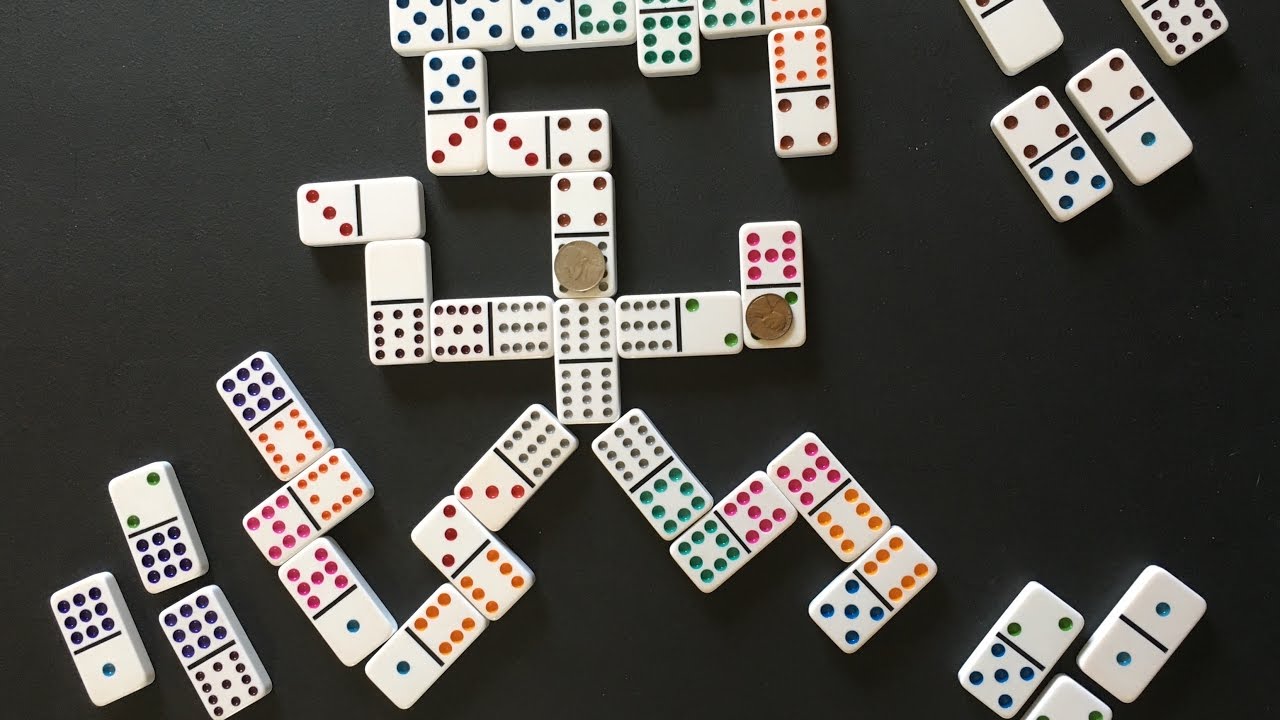 Mexican Train Dominoes Game on black table surface