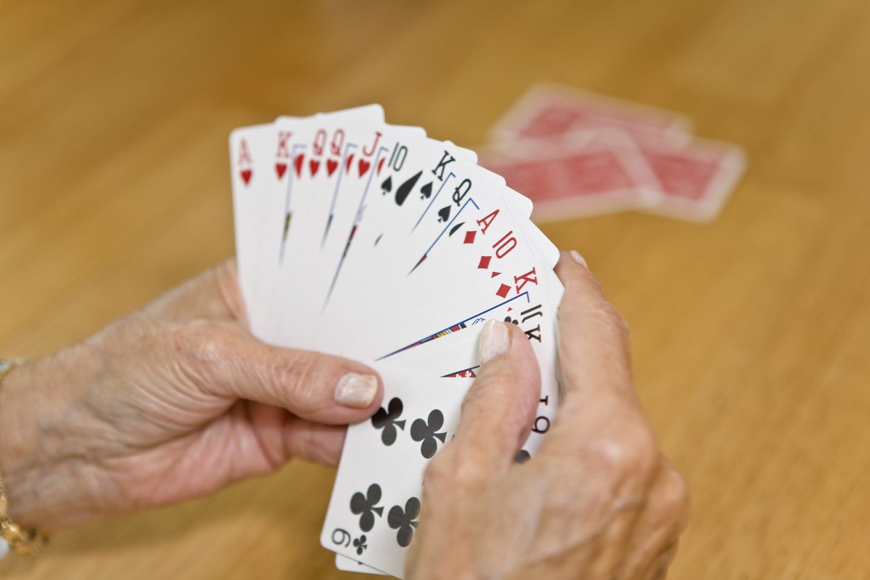Person holds playing cards