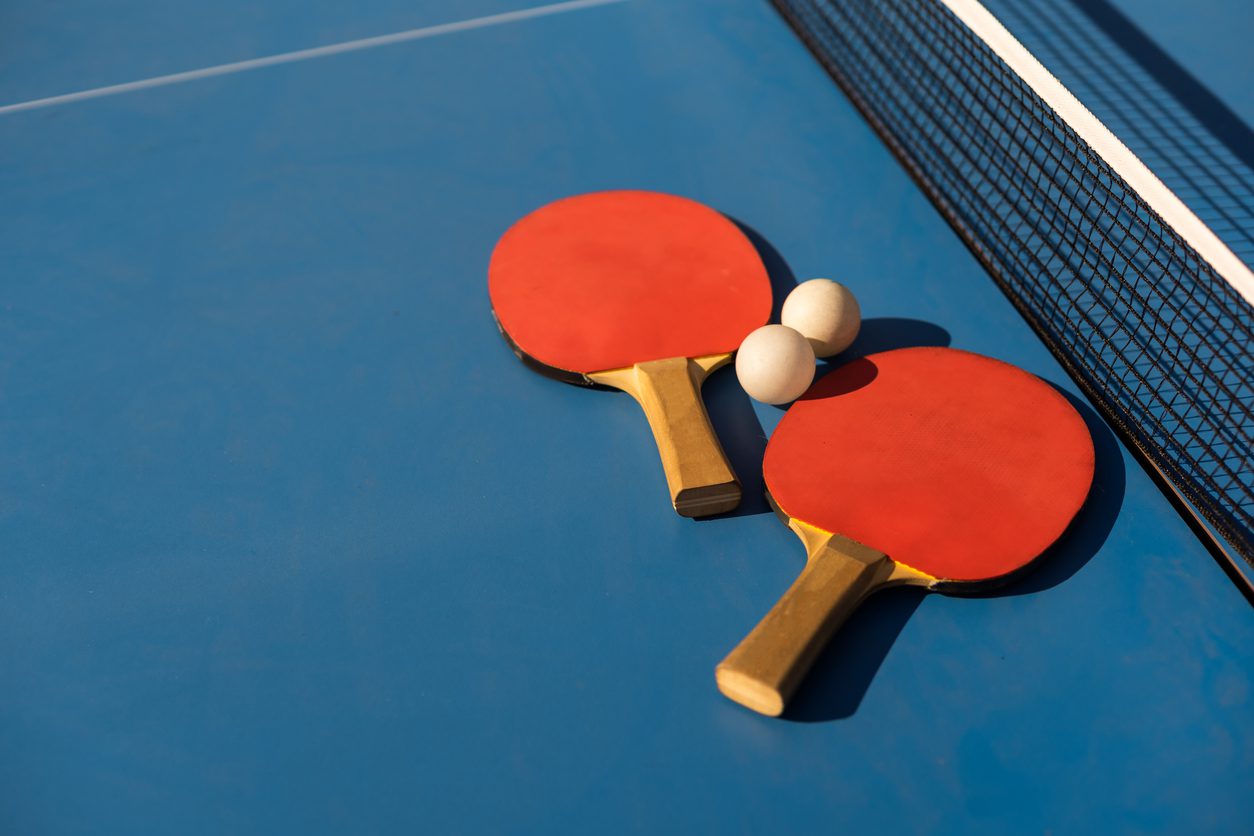Ping pong paddles, two piing pong balls and ping pong table