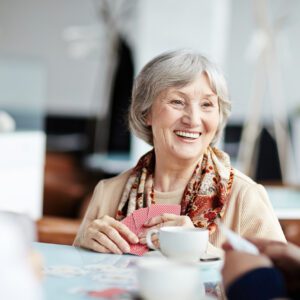 Woman smiles while playing a card game