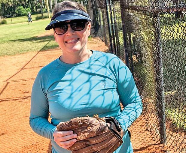 Woman wearing a softball glove