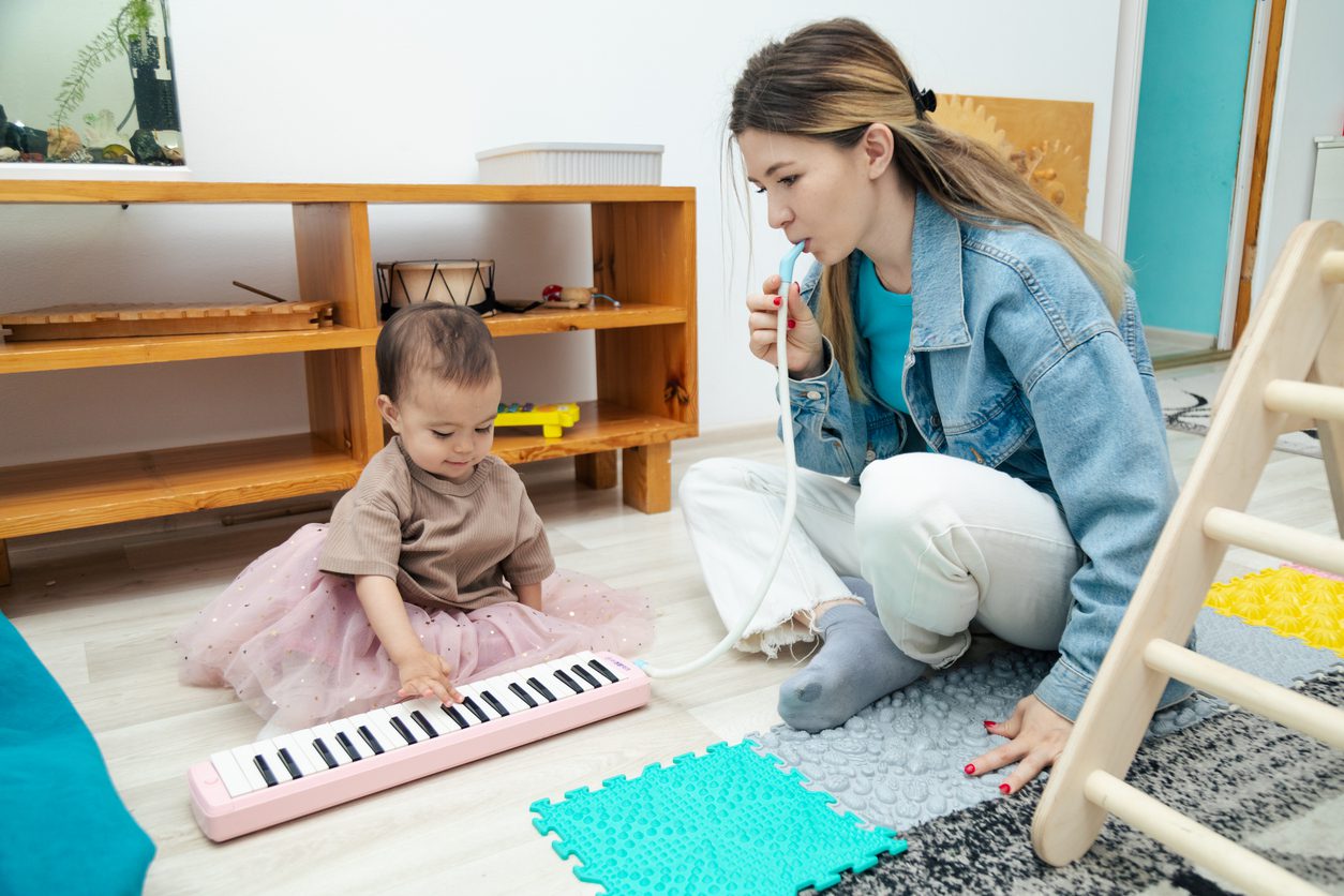 mom and baby playing music