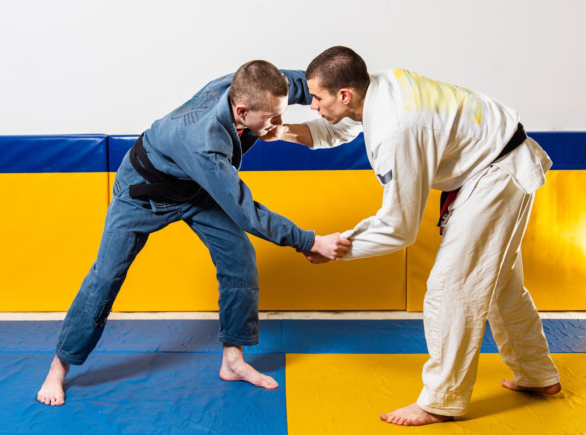 Two adults practicing Jiujitsu