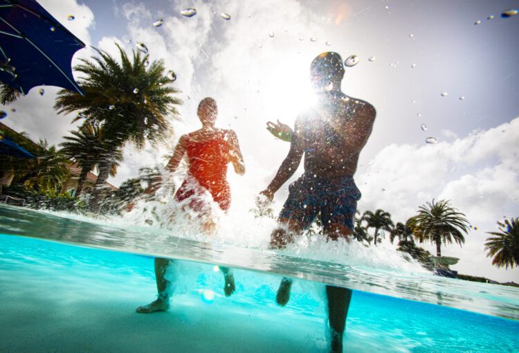 Couple enjoying a resort-style pool at Del Webb Naples in Ave Maria, FL