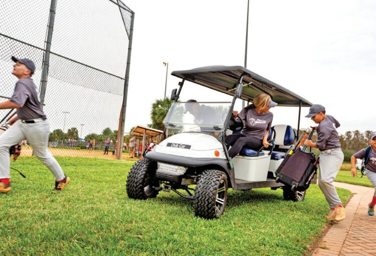 Ariel Hernandez and her Little League team at North Park’s ball field for an evening game.